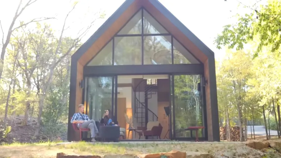 Codie and Isaac sit on the porch of one of Isaac's tiny-home Airbnbs in Waco, Texas.
